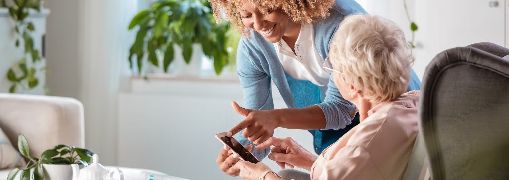 Caregiver helping a senior resident in an independent living community
